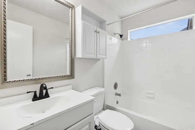 full bathroom featuring toilet, vanity, a textured ceiling, and tub / shower combination