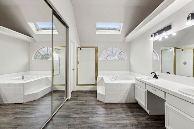 bathroom with vanity, wood-type flooring, lofted ceiling with skylight, and independent shower and bath