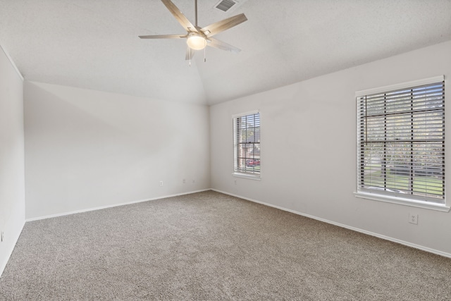 carpeted spare room with ceiling fan and lofted ceiling