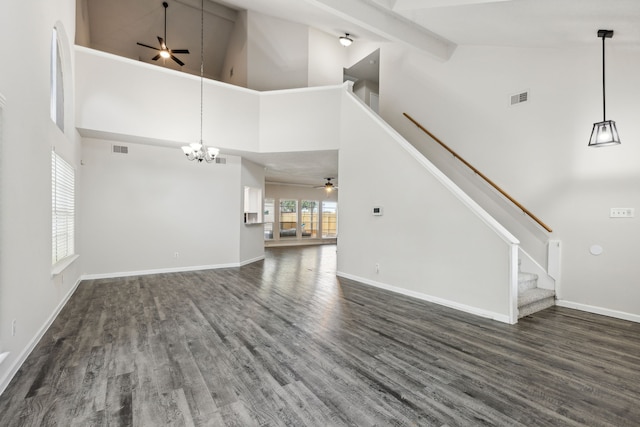 unfurnished living room featuring ceiling fan with notable chandelier, dark hardwood / wood-style flooring, and high vaulted ceiling