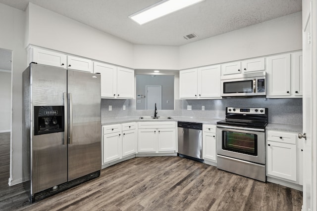 kitchen featuring white cabinets, dark hardwood / wood-style floors, sink, and stainless steel appliances