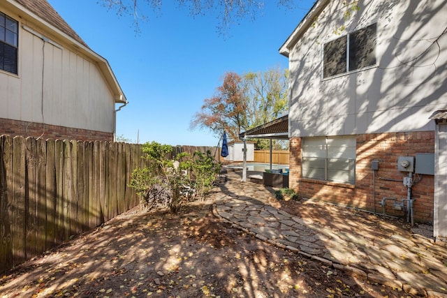 view of yard with a storage unit and a patio area