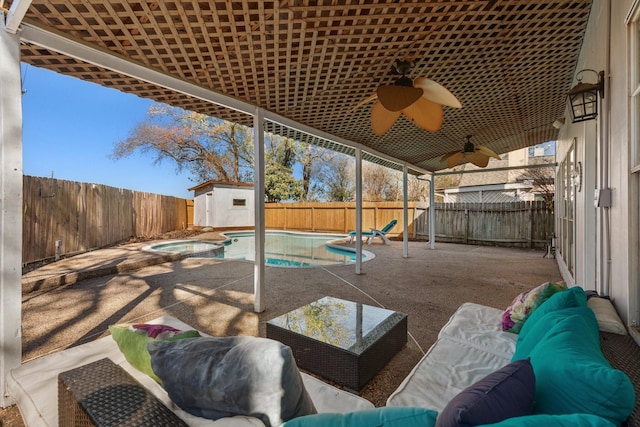 view of patio / terrace with ceiling fan, a storage shed, and a pool with hot tub