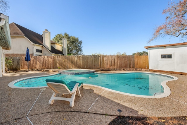 view of pool with an in ground hot tub