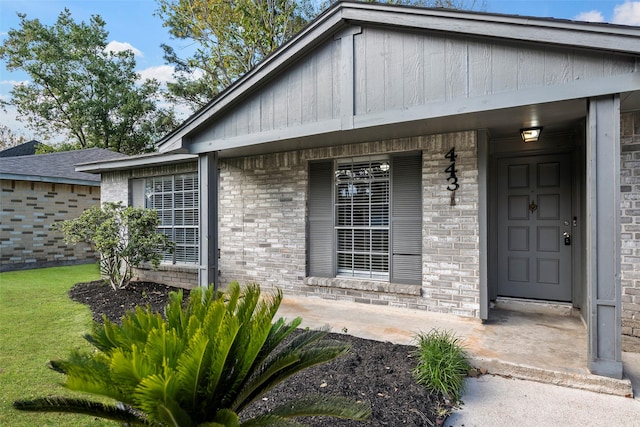 doorway to property featuring a yard