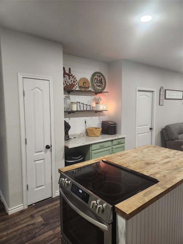 kitchen featuring wooden counters, electric range, green cabinetry, and dark wood-type flooring