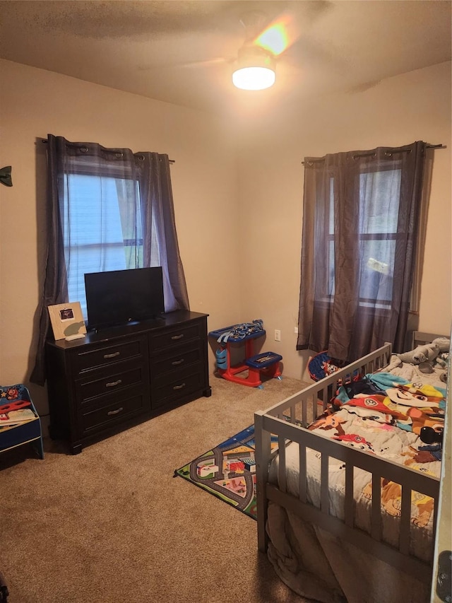 bedroom with ceiling fan and carpet floors