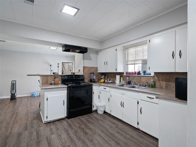 kitchen featuring electric range, sink, dark hardwood / wood-style flooring, kitchen peninsula, and white cabinets