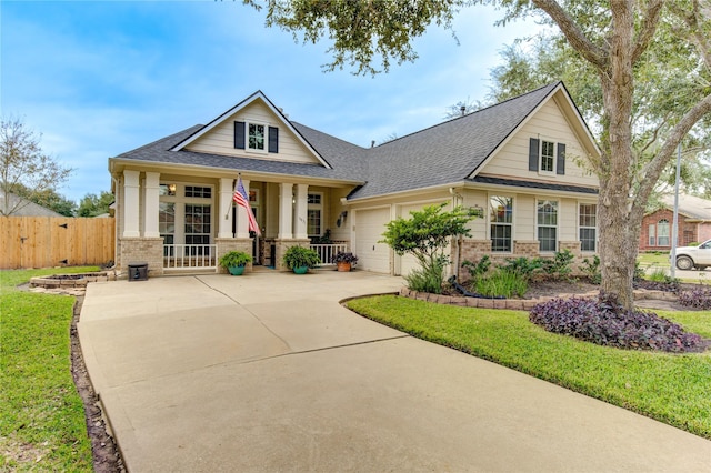 craftsman-style house with a front yard, a porch, and a garage