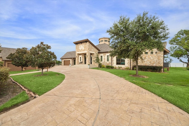 view of front of home with a front lawn and a garage