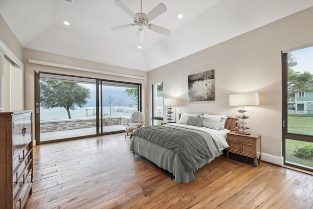 bedroom with access to exterior, multiple windows, ceiling fan, and light wood-type flooring