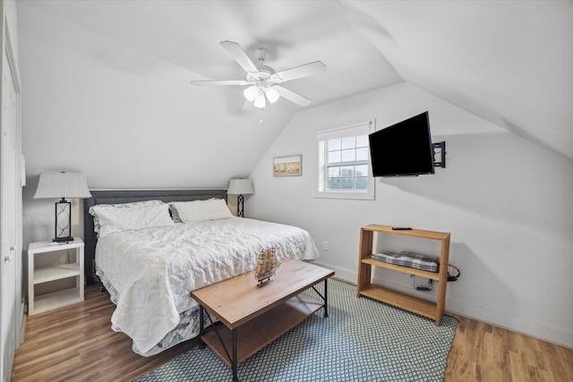 bedroom featuring ceiling fan, wood-type flooring, and lofted ceiling