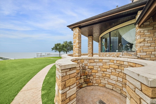 view of patio with a water view