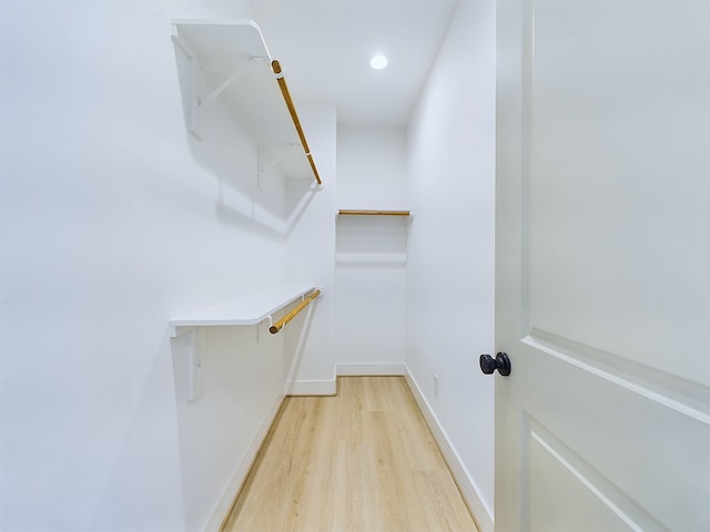 spacious closet featuring light hardwood / wood-style floors