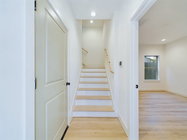 stairway with hardwood / wood-style floors