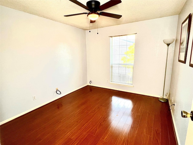 unfurnished room featuring hardwood / wood-style flooring, ceiling fan, and a textured ceiling