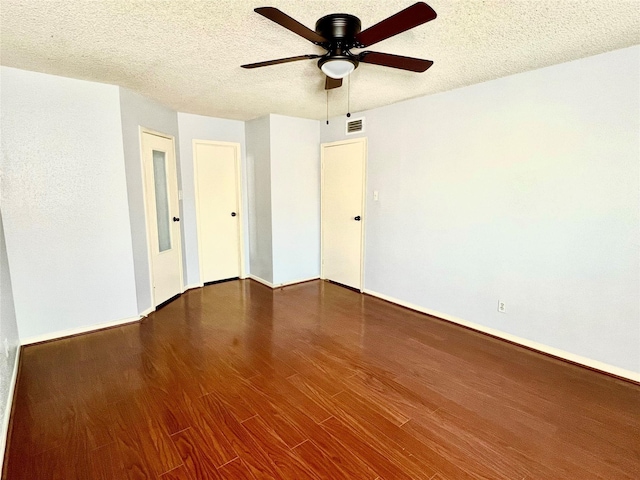 unfurnished room with hardwood / wood-style flooring, ceiling fan, and a textured ceiling