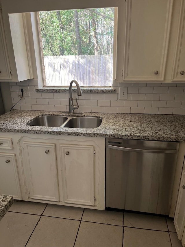 kitchen featuring dishwasher, decorative backsplash, sink, and a wealth of natural light