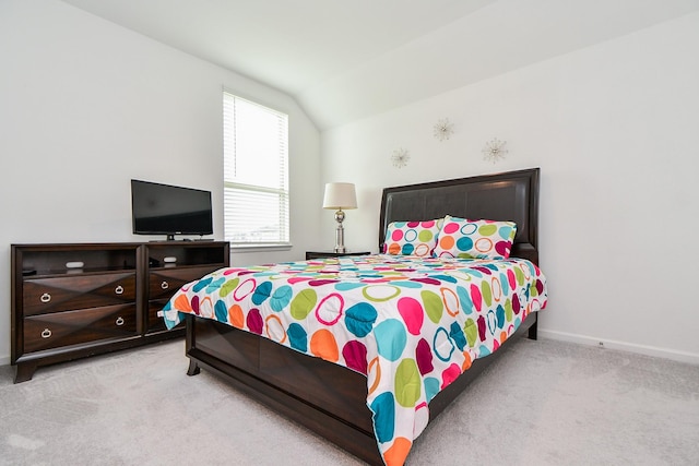 bedroom with light carpet and vaulted ceiling