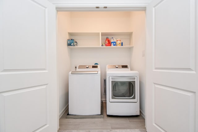 laundry area with washing machine and clothes dryer