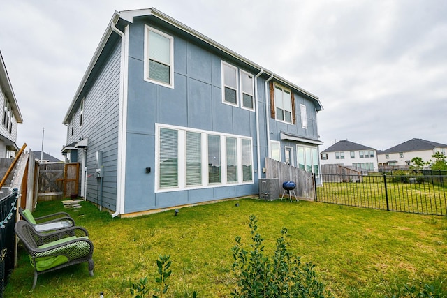 rear view of house with a lawn