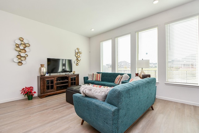 living room with a healthy amount of sunlight and light wood-type flooring