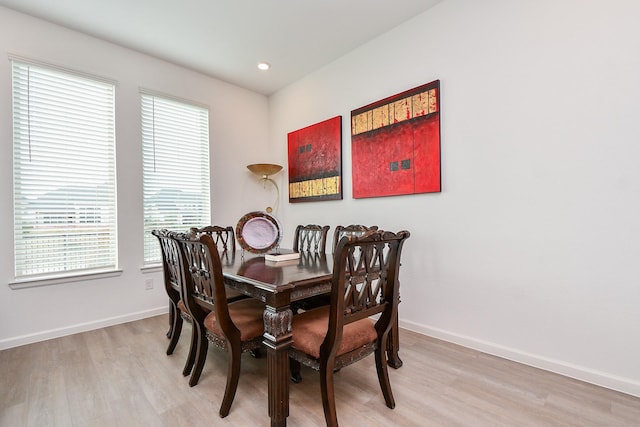 dining area with light hardwood / wood-style floors and a wealth of natural light