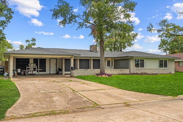 ranch-style home with a front yard and a garage