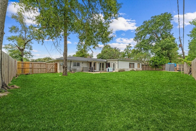 rear view of house with a lawn