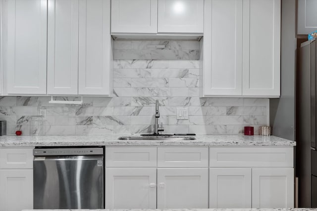 kitchen with light stone countertops, white cabinetry, sink, and appliances with stainless steel finishes