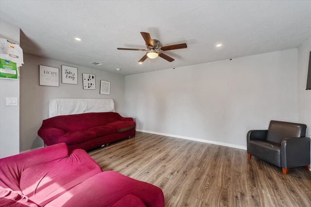 living room featuring ceiling fan and wood-type flooring