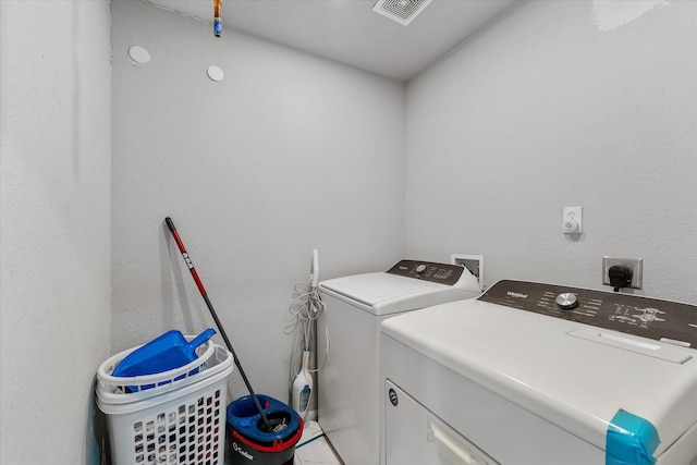 laundry area featuring washing machine and clothes dryer