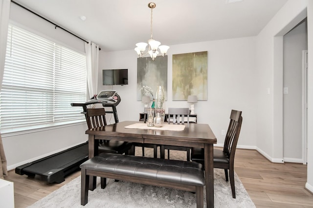 dining room featuring a chandelier and light hardwood / wood-style flooring