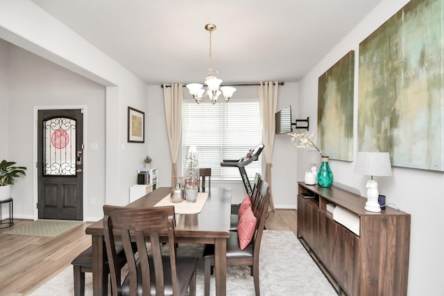 dining space featuring a chandelier and light wood-type flooring