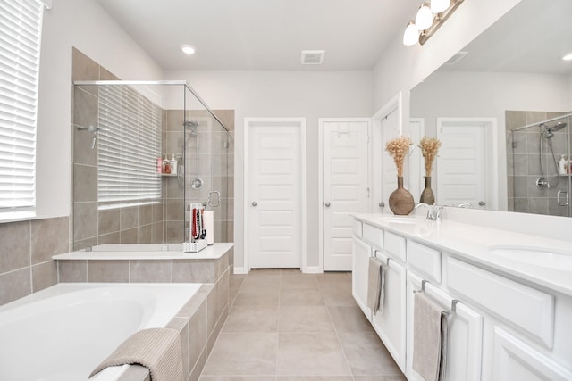 bathroom with tile patterned flooring, vanity, and independent shower and bath