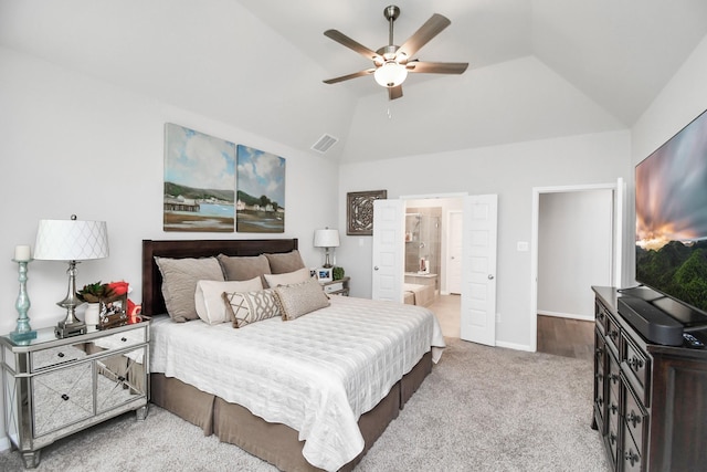 carpeted bedroom with ceiling fan, lofted ceiling, and ensuite bath