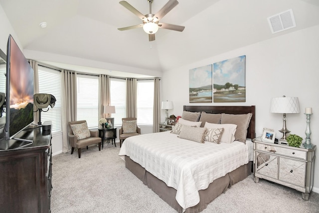 carpeted bedroom with ceiling fan and vaulted ceiling