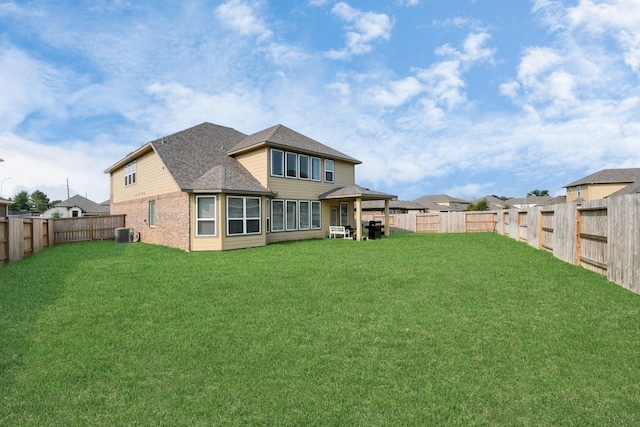 back of house featuring cooling unit and a lawn