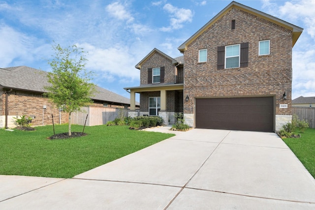 view of front of property featuring a front yard and a garage