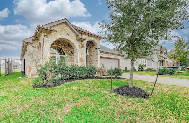 mediterranean / spanish home with a garage and a front yard