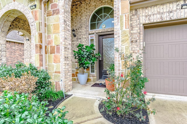 view of exterior entry with a garage