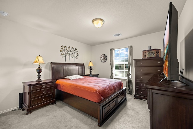 carpeted bedroom featuring a textured ceiling