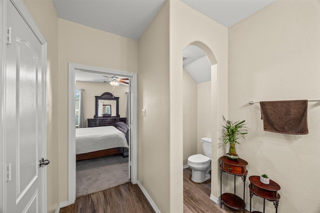 bathroom with hardwood / wood-style flooring, toilet, and ceiling fan