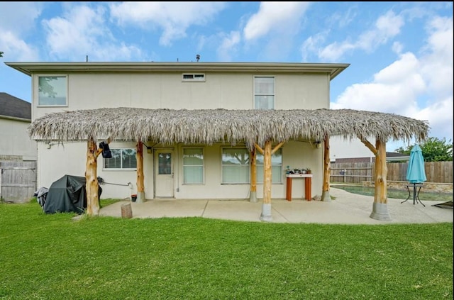 rear view of property featuring a lawn