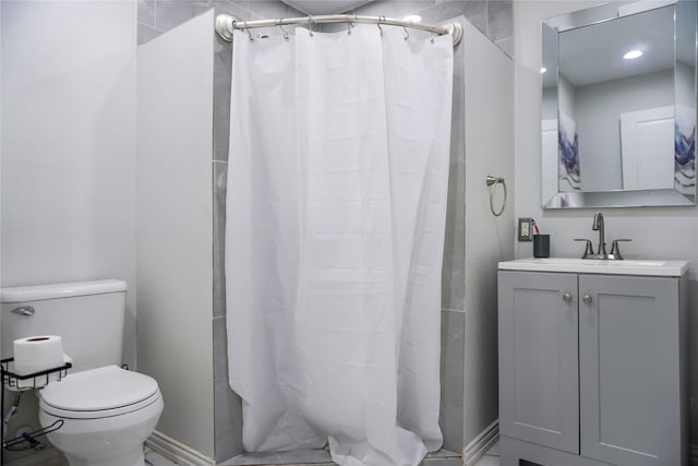 bathroom with vanity, curtained shower, and toilet