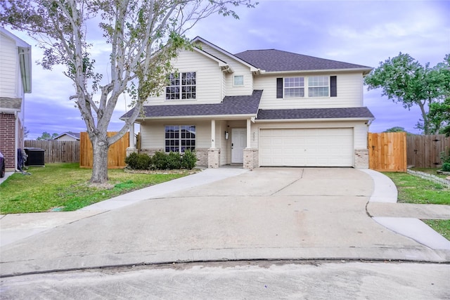 view of front of home with cooling unit, a front lawn, and a garage