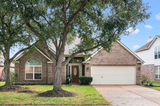 view of front of home with a garage and a front lawn