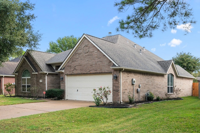 view of front of property with a garage and a front lawn