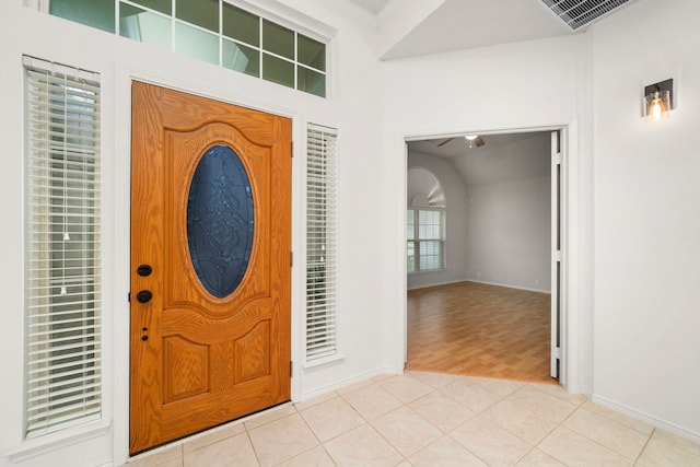 foyer entrance with light hardwood / wood-style floors and ceiling fan