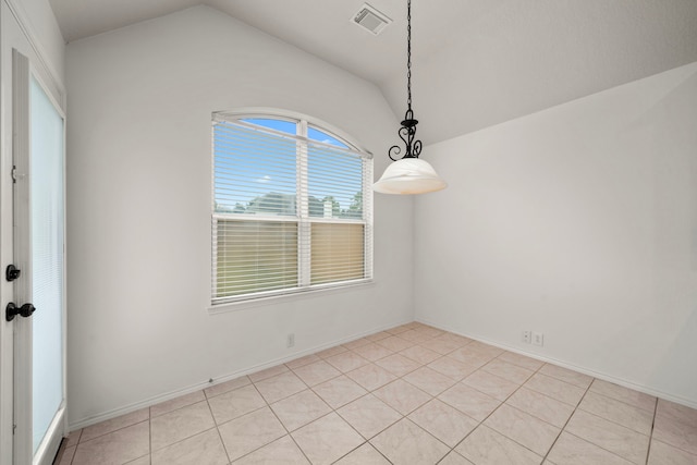 unfurnished room featuring lofted ceiling and light tile patterned floors